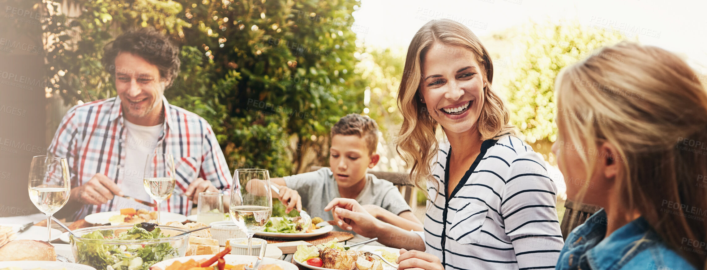 Buy stock photo Family, parents and children at outdoor lunch with smile, celebration or eating together in backyard. Mother, father and kids at table for garden picnic with food, laughing and fun bonding on banner