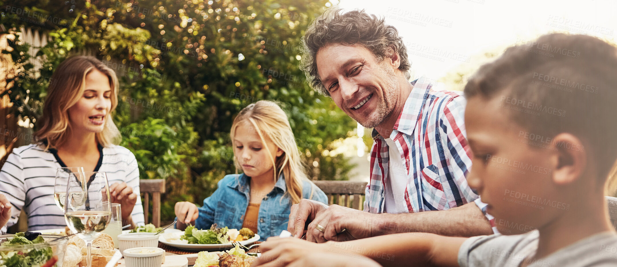 Buy stock photo Family, parents and children at patio lunch with smile, celebration or eating together in backyard. Mother, father and kids at table for outdoor garden picnic with food, chat and bonding on banner