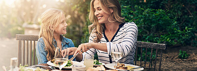 Buy stock photo Help, mom and child at outdoor lunch with smile, thanksgiving and family eating together in backyard. Care, mother and daughter at table for garden picnic with food, happy bonding and love on banner