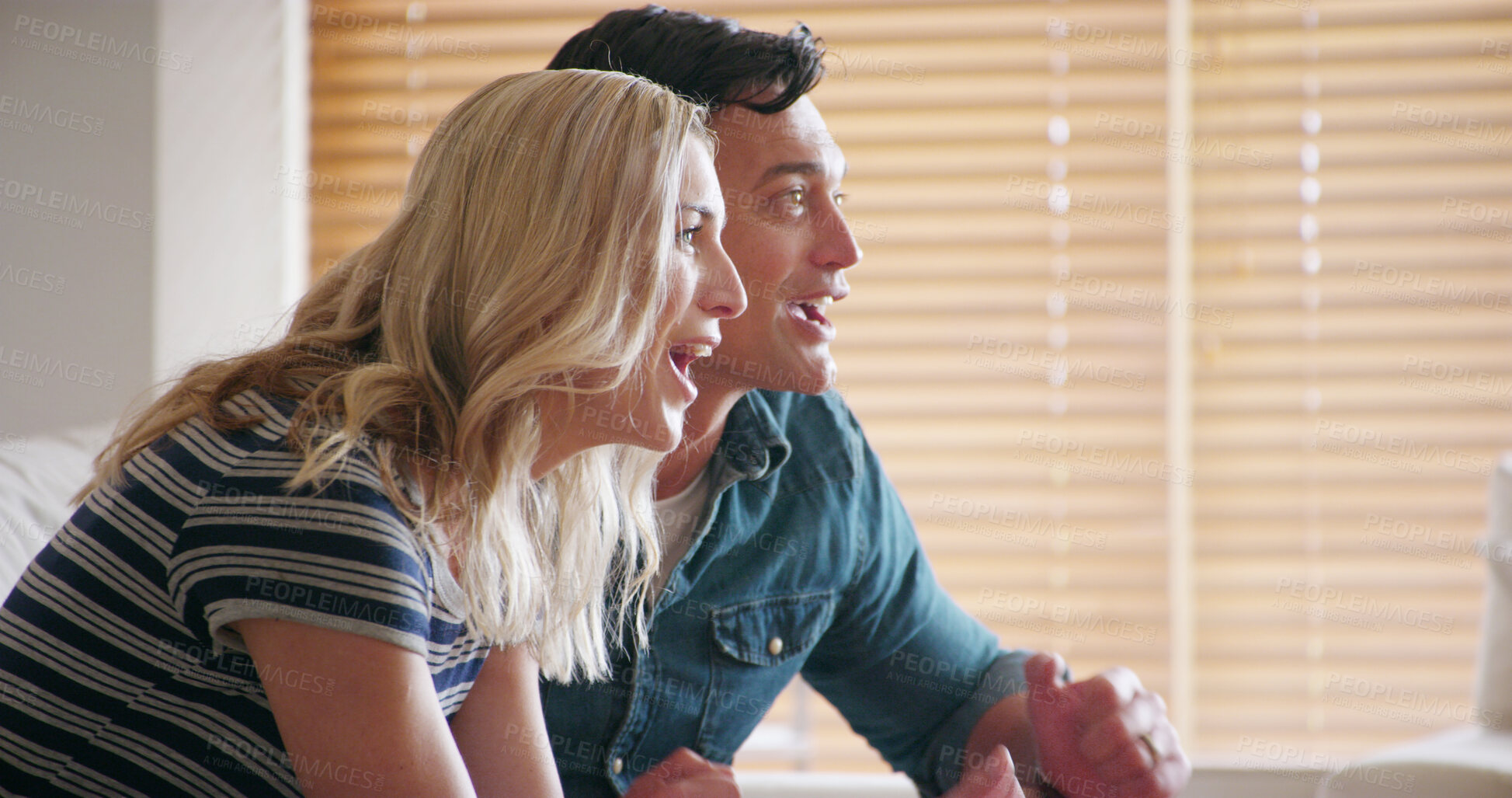 Buy stock photo Excited, game and tv with couple, winner and live streaming sport on living room sofa. Competition, lounge and fan with watching, waiting and entertainment from winning goal and victory in match 