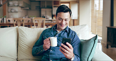 Buy stock photo Man, smartphone and smile with coffee on sofa for texting, chat or reading funny post on mobile app in home. Person, phone and relax with tea cup, drink and happy for contact on social media in house