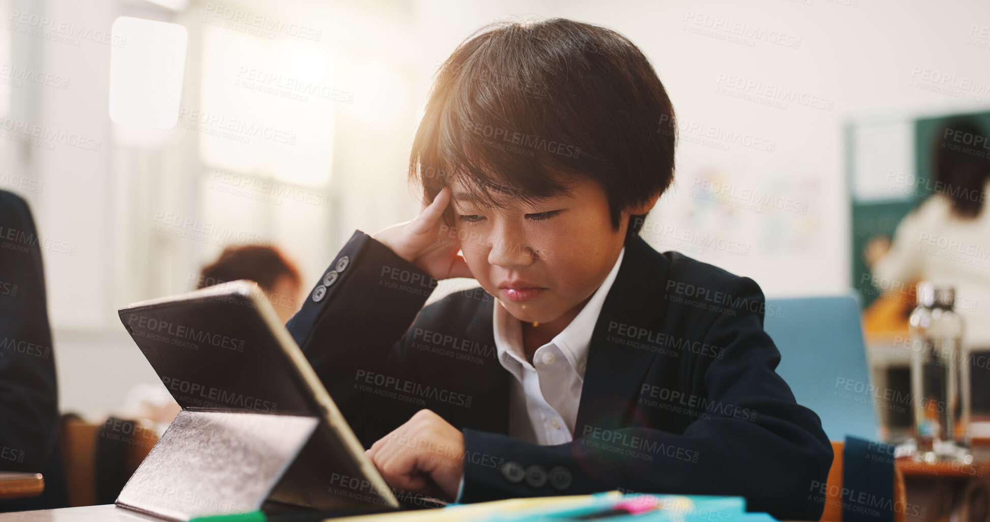 Buy stock photo School, tablet and sad child with stress, leaning and development in classroom. Assessment, anxiety and test with virtual language course, research and japanese student app for knowledge on website