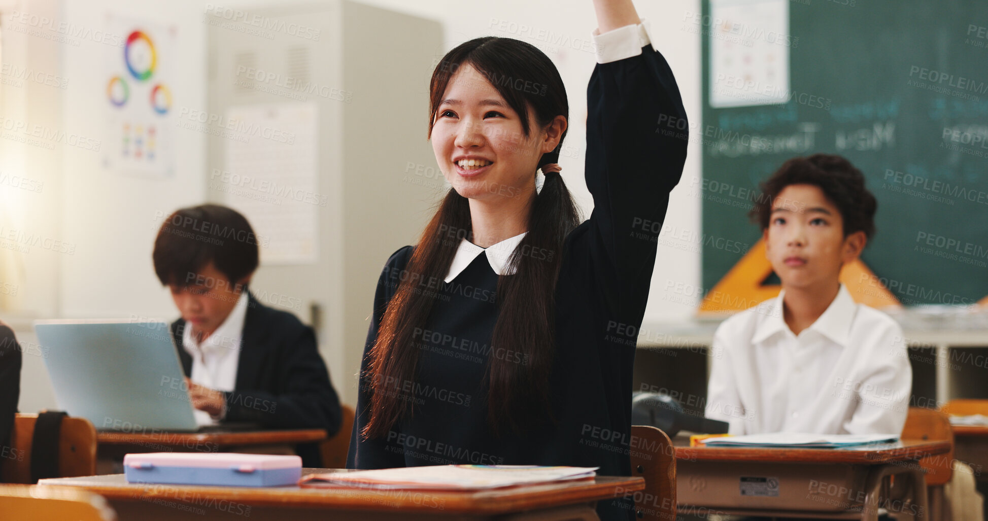 Buy stock photo Girl, raised hand and question in classroom for smile, education and excited with problem solving for test. School kids, learner and sign for answer, solution and happy for quiz at academy in Japan