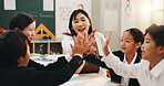 Teacher, children and high five in classroom for language development, group project and growth. Japanese students, reading together or studying with educator for support, knowledge and celebration