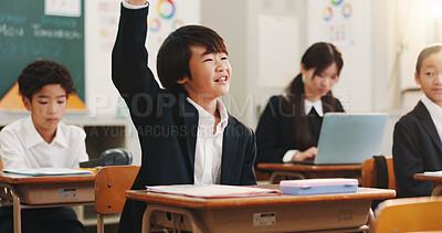 Buy stock photo Boy, raised hand and happy in classroom for learning, question and study with problem solving test. School kids, learner and sign for answer, solution and education with quiz at academy in Japan