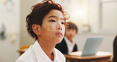 Buy stock photo Education, child or thinking in class for learning, daydreaming and distracted in lesson. Japanese boy, face or student in elementary school for development, growth and kid with ADHD in academy