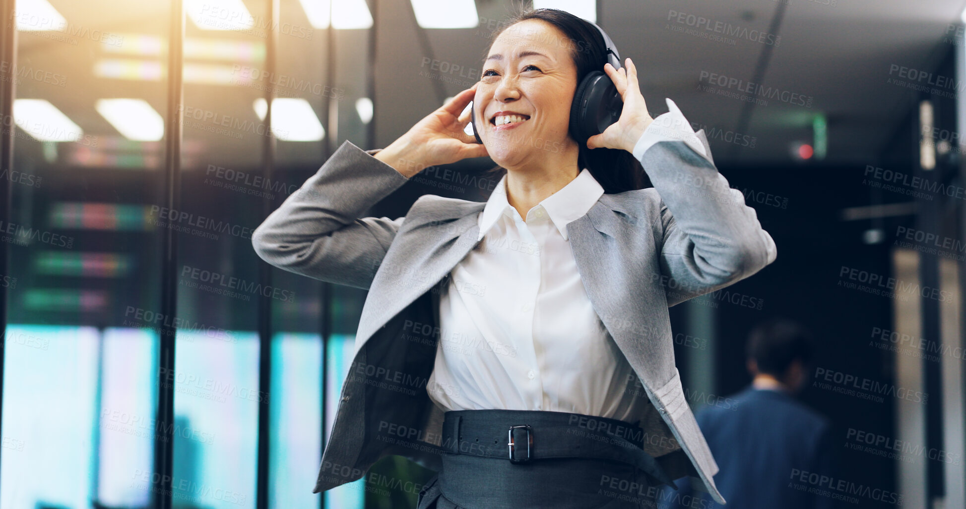 Buy stock photo Woman, headphones and employee walking in office, hearing music and celebration of success. Female person, professional and morning dancing in workplace for achievement, listening and sound in Japan