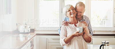 Buy stock photo Smile, hug and senior couple with coffee in kitchen for love, morning romance or marriage in home. Retirement, happy man and woman embrace for support, loyalty or care with partner laughing on banner