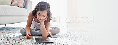 Buy stock photo Streaming, movies and child with tablet, home and watching of cartoons, relax and smile for video. Living room, banner and entertainment for kid, digital and subscription to app and mockup space