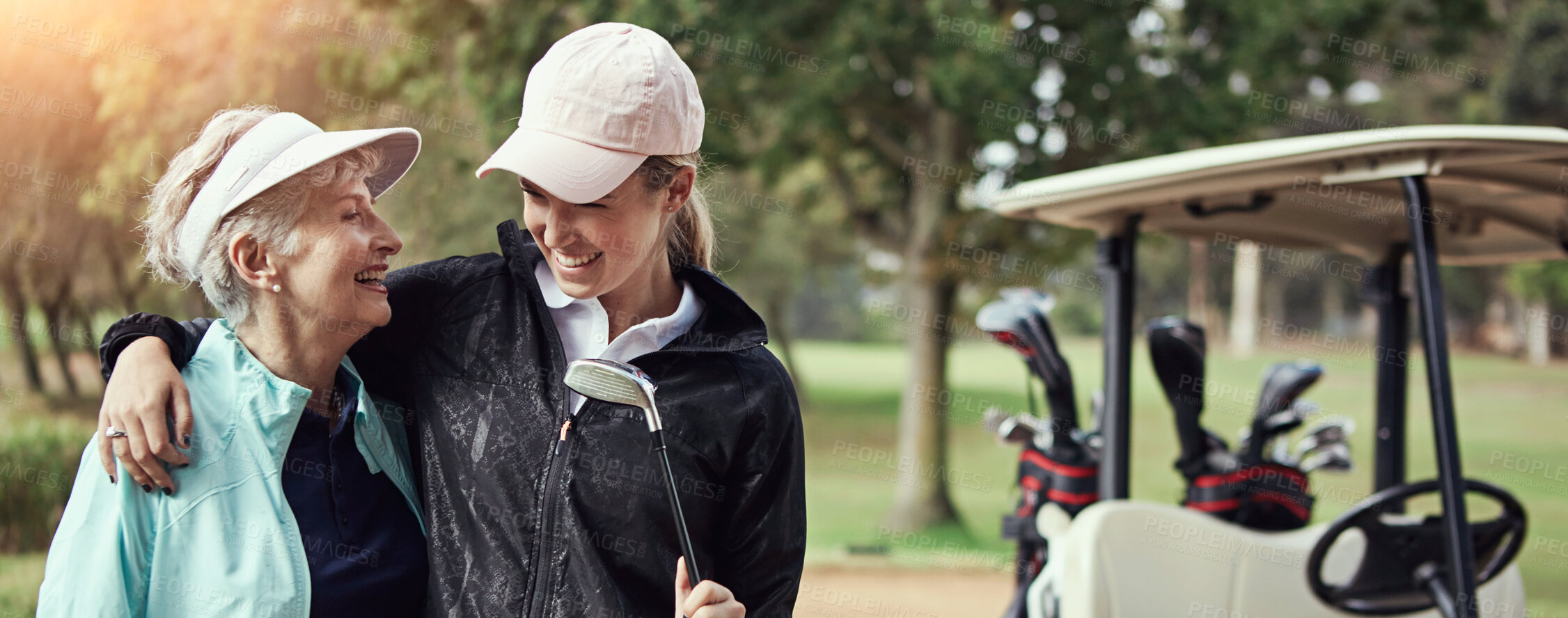 Buy stock photo Mother, daughter and hug for golf outdoor of sports training, bonding together and fitness hobby. Mature, women and embrace of putter for family activity, fun competition and match practice in nature