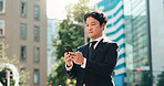 Man, reading and phone in city for business, travel and research for urban development in Tokyo. Mature investor, mobile and scroll in Japanese town for news, investment opportunity or economy growth