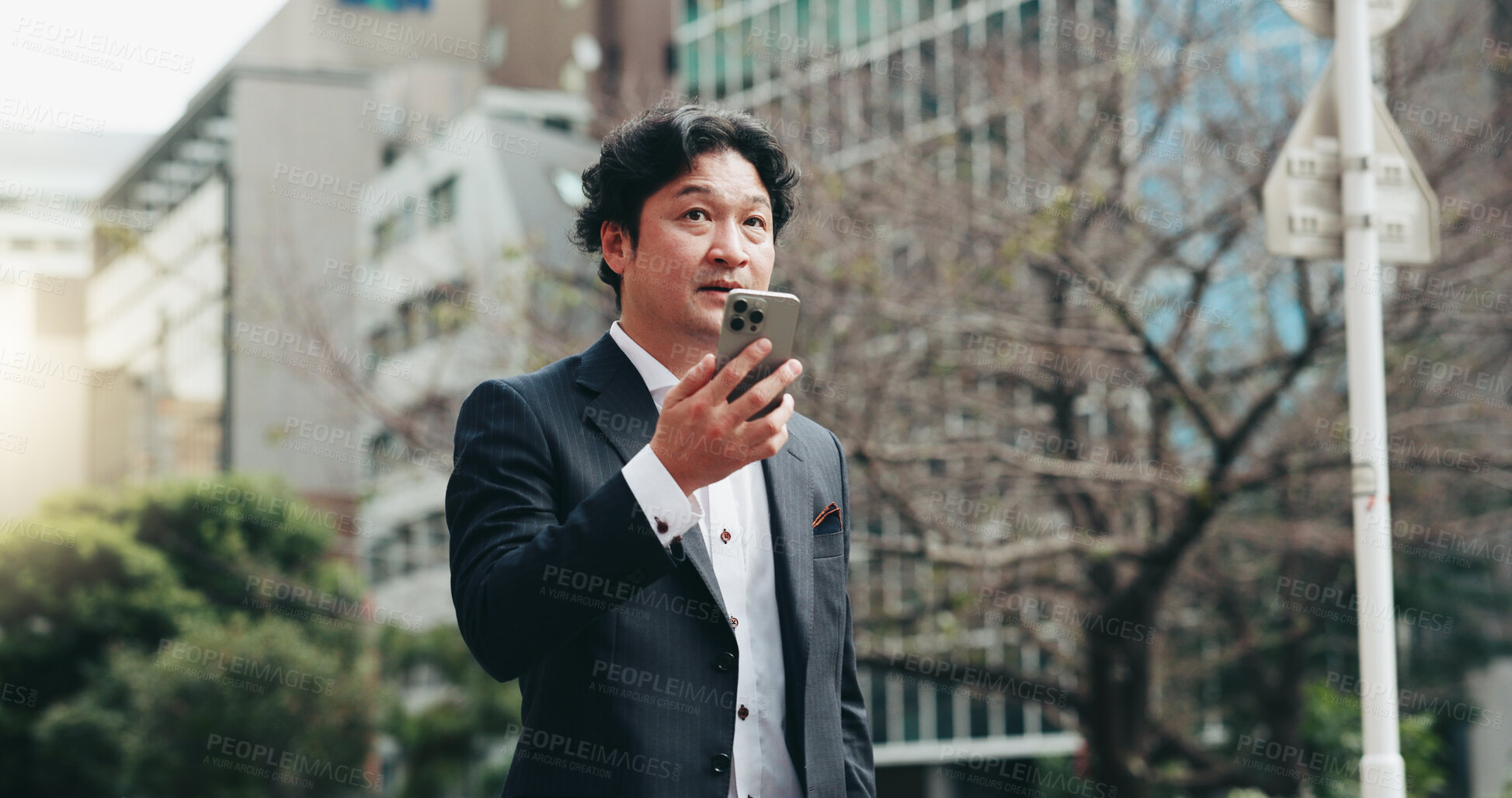 Buy stock photo Japanese, business and man with phone speaker for discussion, schedule update and negotiation chat. Male person, mobile sound and communication of audio, contact information and urban travel in Japan