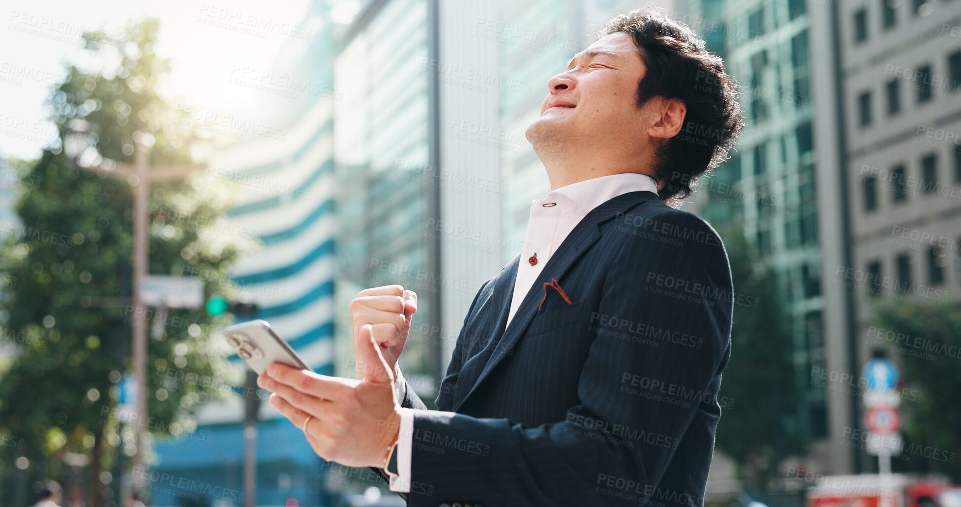Buy stock photo Businessman, phone and celebration in city for success, client acquisition and development deal. Japanese person, mobile and fist bump outdoor for financial profit, investment growth and achievement