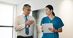 Doctor, nurse and clipboard for healthcare, collaboration and medical feedback with discussion in hospital. Mature man, woman and planning for health report, teamwork or research with advice in Japan