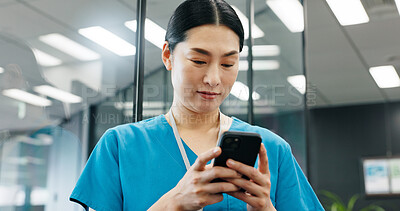 Buy stock photo Woman, nurse and phone in hospital for healthcare, schedule update and connectivity. Japanese surgeon, reading or mobile in clinic for patient feedback, telehealth services or news email with results