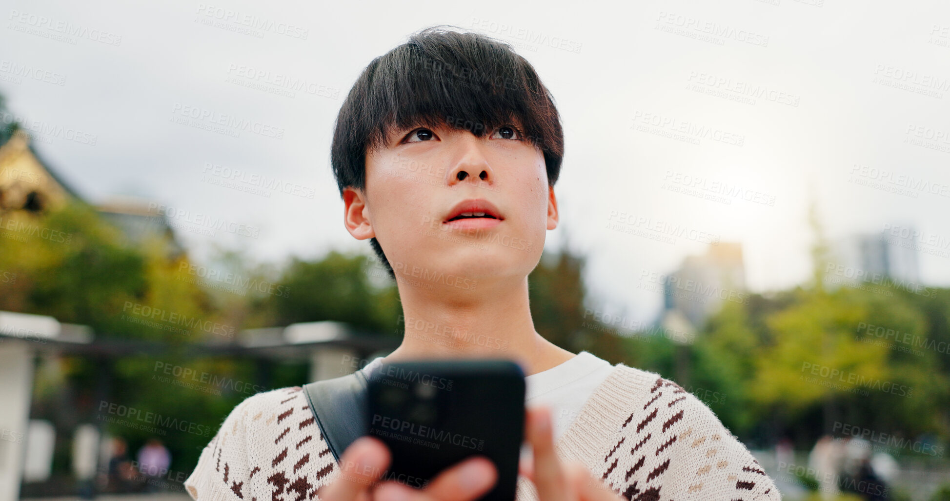 Buy stock photo Cellphone, travel and Japanese man in city with navigation for university with mobile app. Town, phone and male student with online directions for college campus with international exchange program.