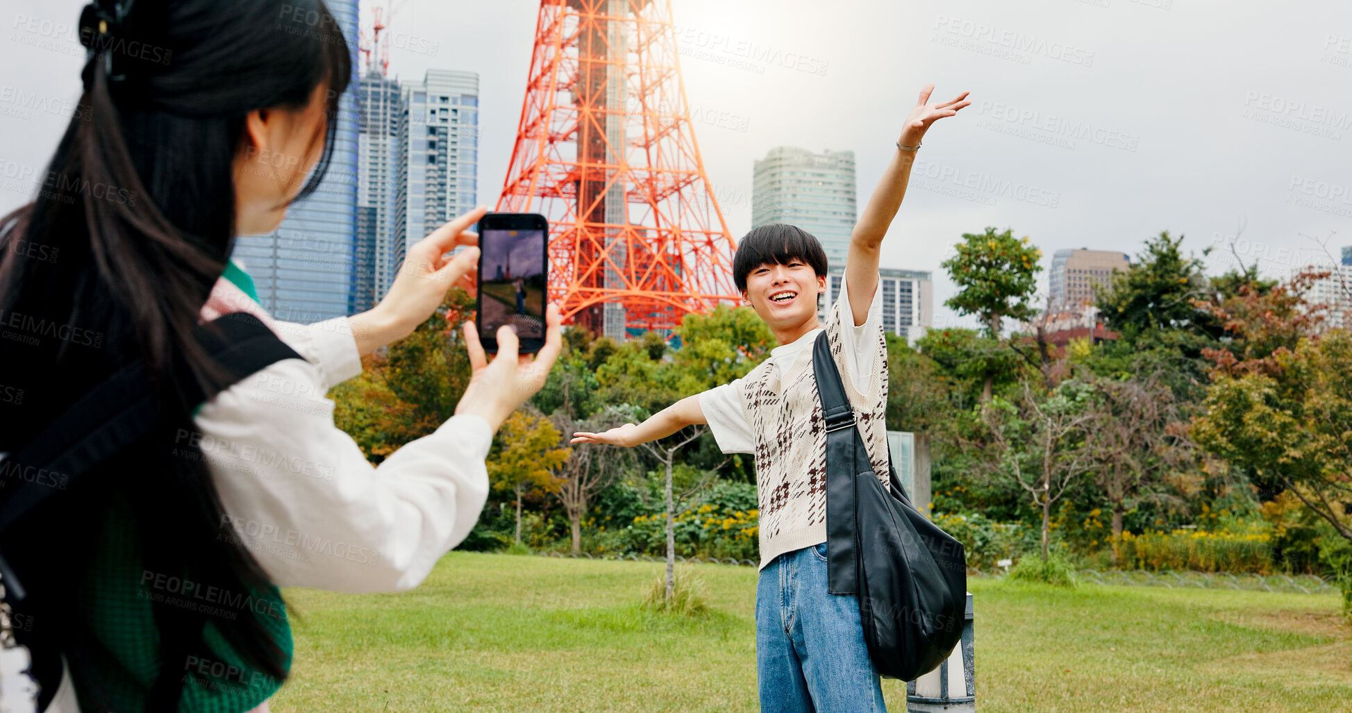 Buy stock photo Travel, photography and bonding of couple, phone and capturing of moment, tourism and content creation. Outdoor, influencer and people in city, photographer and picture of Tokyo Tower in Japan