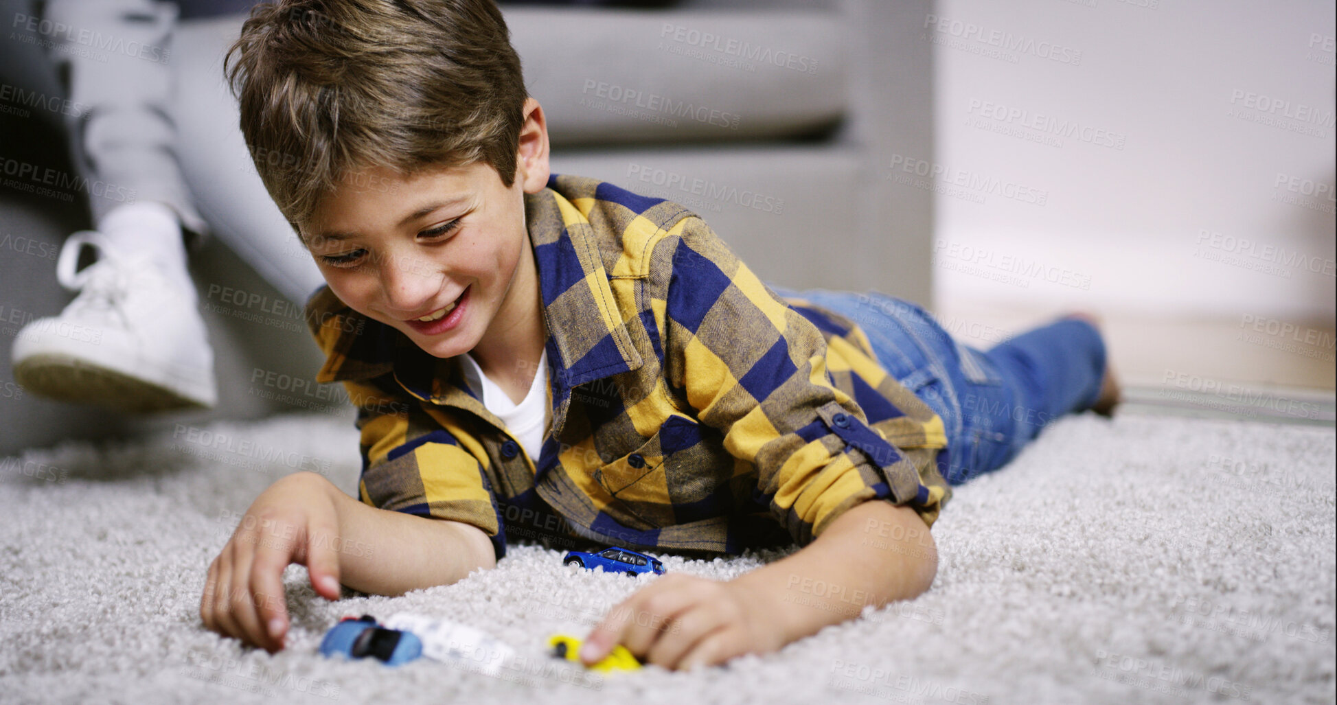 Buy stock photo Boy, kid and playing with cars in home for child development, creative imagination or happy with fantasy game. Smile, growth or toys on carpet for fun activity, cognitive skills or sensory experience