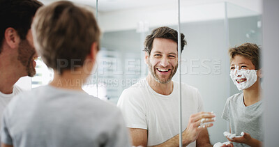 Buy stock photo Shaving cream, father and son in bathroom, reflection and playful with grooming routine. Family, parent and dad with boy, home or skincare with foam, smile or treatment with fun, teaching or learning