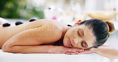 Buy stock photo Woman, relax and hot stones at spa outdoor for healing muscle tissue, stress relief and massage wellness. Person, sleeping and warm rocks with holistic treatment, natural detox and spiritual recovery