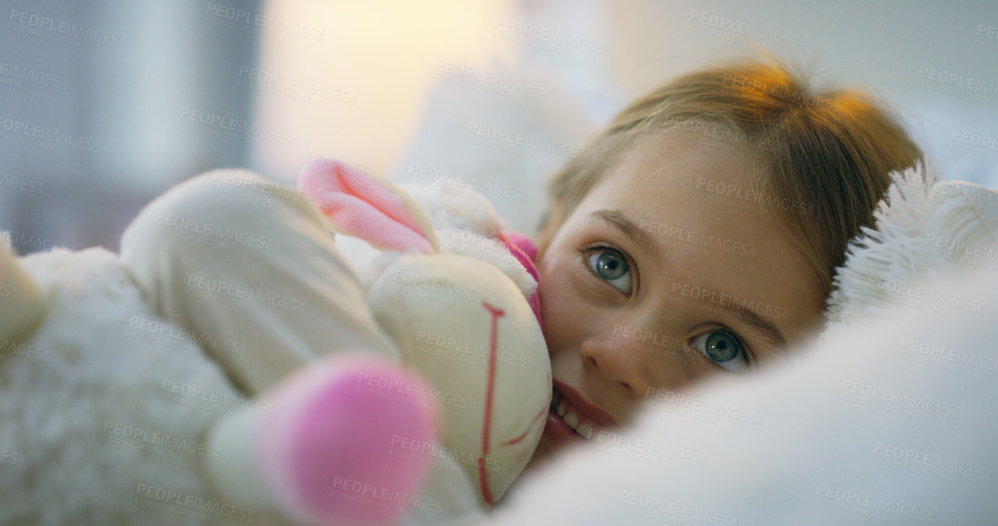 Buy stock photo Child, toy and cuddle as playful, happy and comfortable in home or bedroom for bonding, joy and care. Little girl, cheerful and excited with stuffed animal for relax, sleep and rest in house as kid