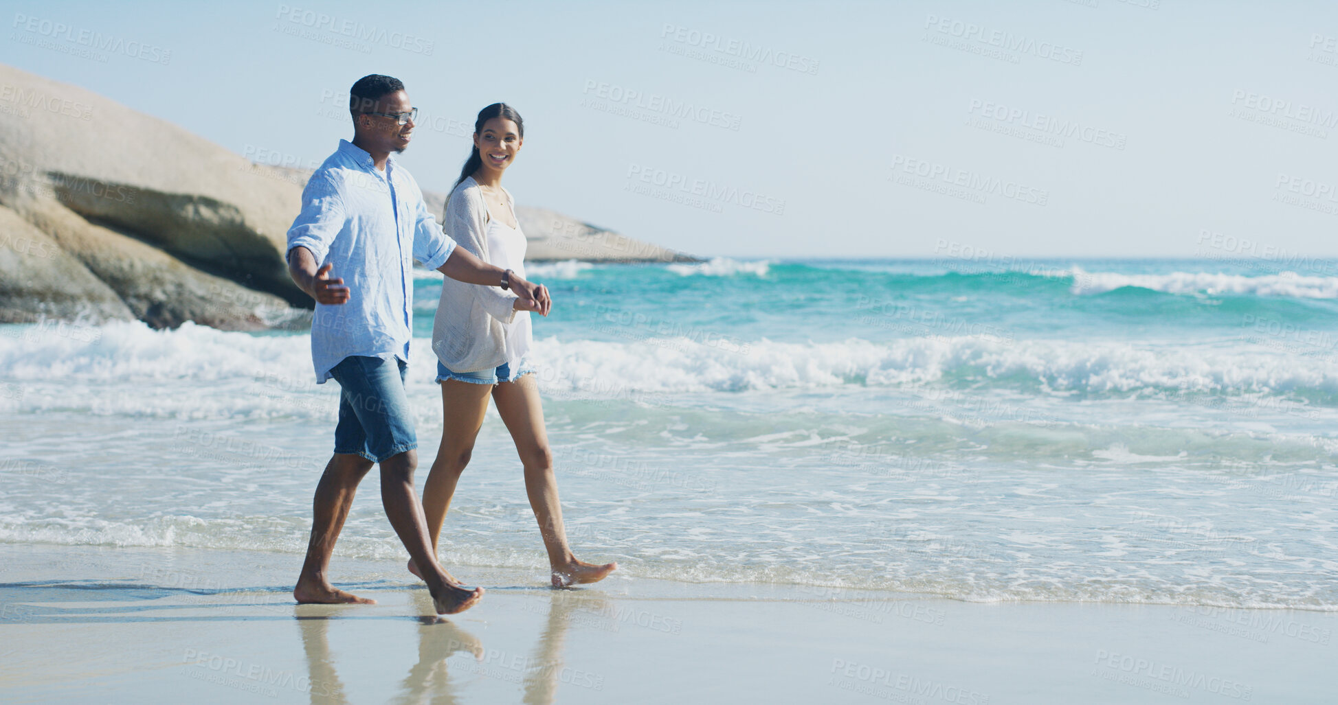 Buy stock photo Beach, couple and holding hands with walking for holiday, travel vacation and bonding together by sea. Happy people, woman and man with commitment in interracial relationship, love and trust in Miami