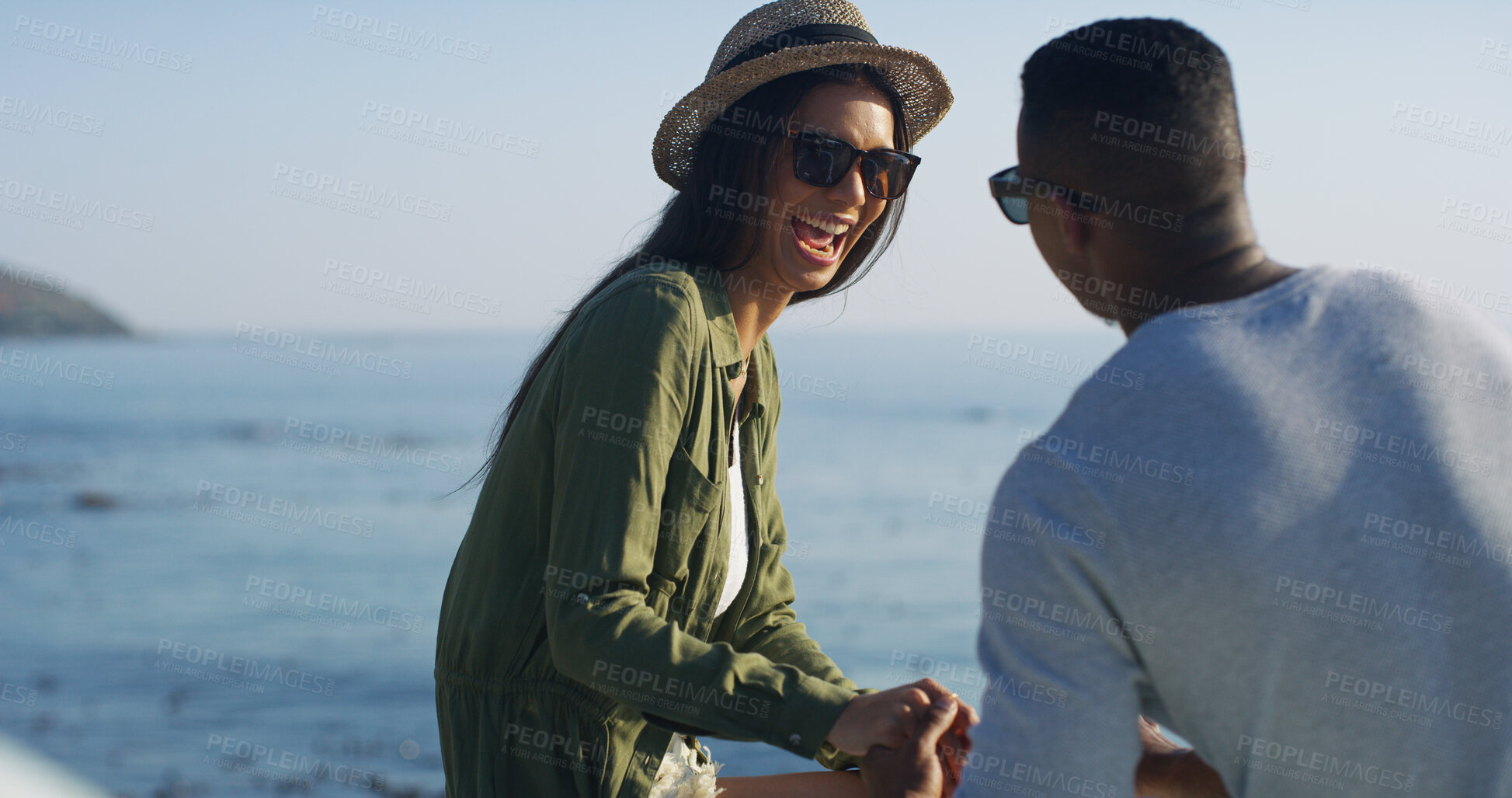 Buy stock photo Ocean, couple and love with holding hands for vacation, travel holiday and outdoor for bonding together. Happy people, woman and man with commitment in healthy relationship, laughing and romantic