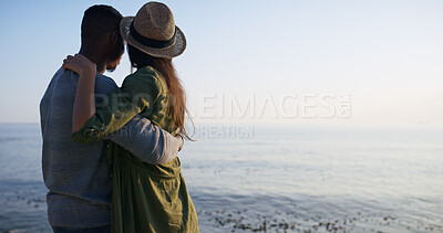 Buy stock photo Morning, ocean and couple on vacation, hug and scenery of nature, tourism and date for anniversary. Outdoor, space and people on holiday, back and adventure for romance, relationship and mockup