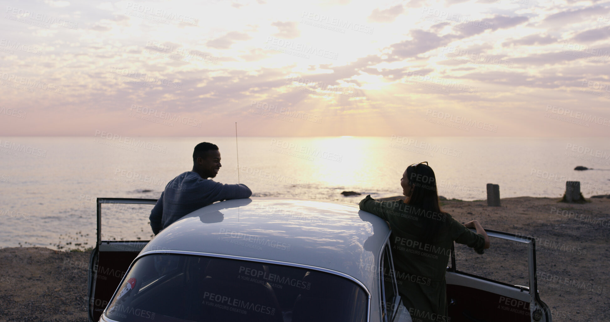 Buy stock photo Road trip, sunset and travel with couple at beach for ocean view, summer vacation and adventure. Love, holiday and tourist with back of people and car in nature for relax, transportation and drive