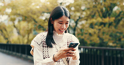 Buy stock photo Japanese woman, laughing and phone in street for online networking, dating app and funny text message. Person, smartphone and happy for social media meme, notification and browsing internet on bridge