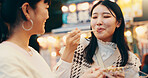 City, asian women and happy with street food, travel and snack for friends with meal, students and road. Outdoor, delicious and cuisine for celebration of reunion, people and sharing in Japan