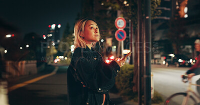 Buy stock photo Night, travel and woman in city with phone, connection or checking online location for public transport schedule. Smartphone, search and Japanese girl in street with mobile app for late urban commute