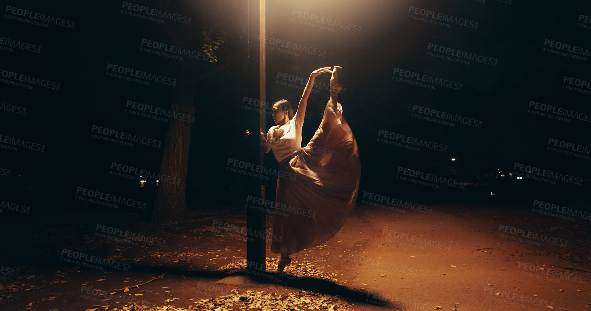 Buy stock photo Ballet, dance and lamp with Japanese woman in city for balance, theater and elegant performance. Talent, art and feminine with person or ballerina dancer at night for recital, music or practice