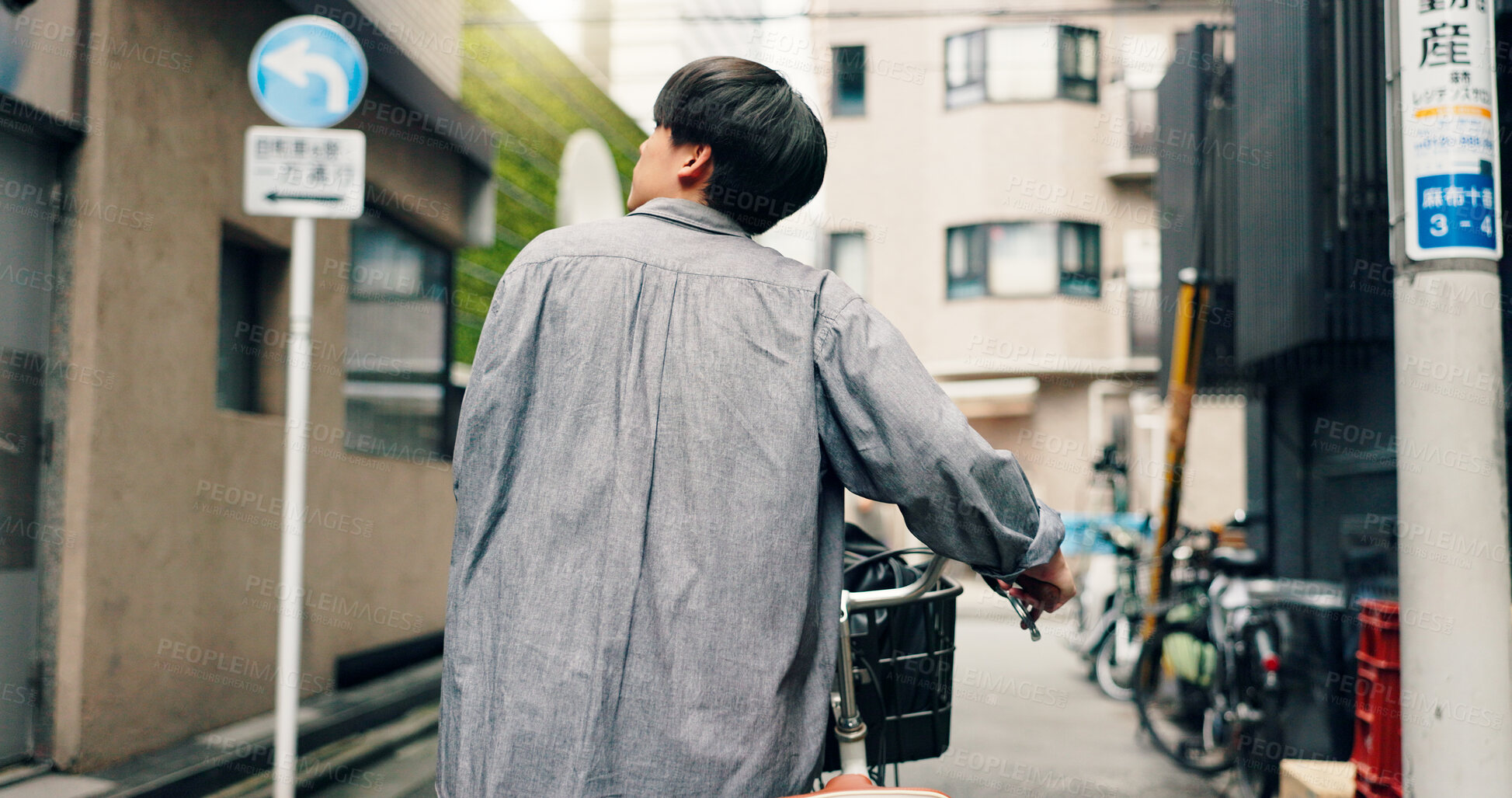 Buy stock photo Thinking, walking and Asian man with bicycle in city for commute, journey and explore town. Travel, cycling and back of person on bike for trip, sustainability and eco friendly transport in Japan