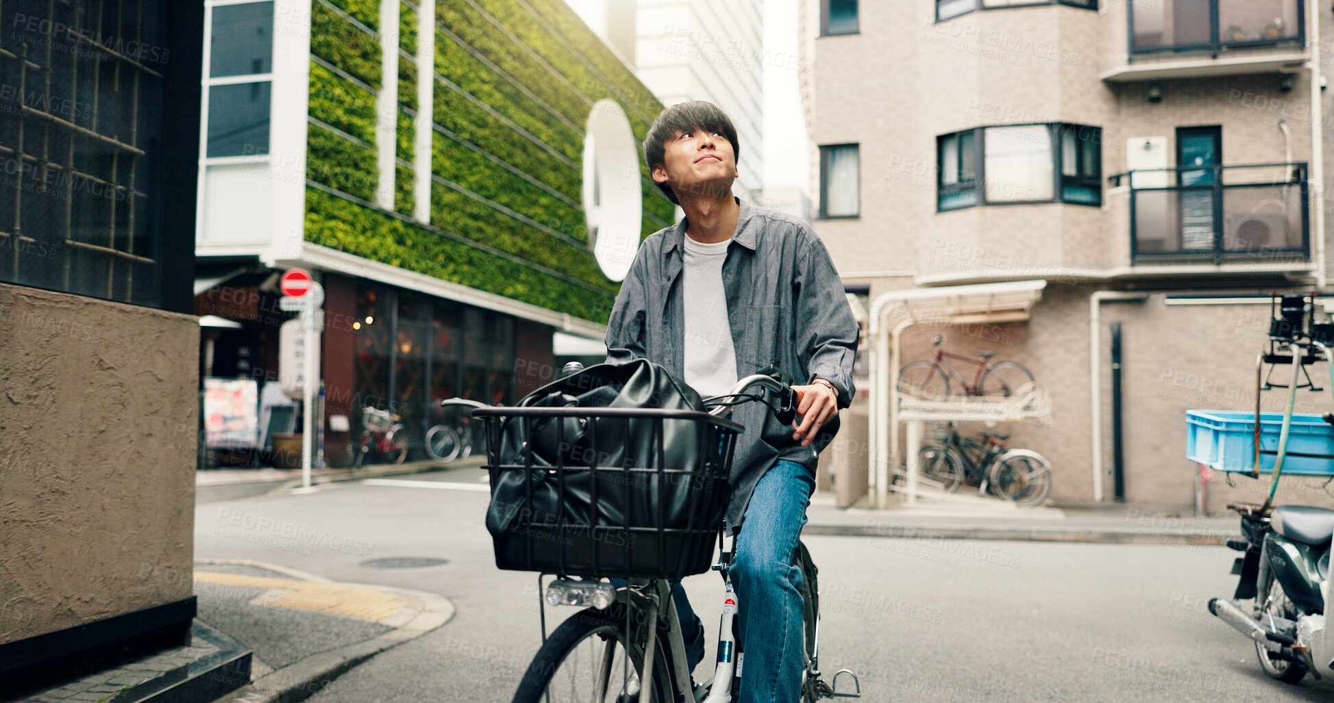 Buy stock photo Travel, sightseeing and Asian man with bicycle in city for morning commute, adventure and journey. Explore, cycling and person on bike for trip, sustainability and eco friendly transport in Japan