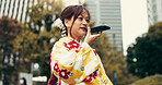 Asian woman, talking and city with speaker phone for audio message, communication or voice note. Japan, female person or tourist with mobile smartphone for recording, chat or vocal app in urban town