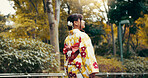 Thinking, kimono and park with Japanese woman walking for heritage, festival ceremony and culture. Traditional clothes, fashion and vision with asian person and outdoor for pride, reflection or peace
