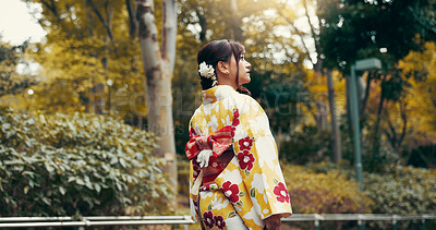 Buy stock photo Thinking, kimono and park with Japanese woman walking for heritage, festival ceremony and culture. Traditional clothes, fashion and vision with person and japan outdoor for pride, reflection or peace