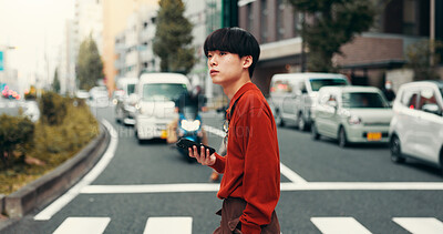 Buy stock photo City, walking and man on crosswalk with phone, morning commute or mobile app for road navigation. Urban, travel and Japanese university student on pedestrian crossing with smartphone for connectivity