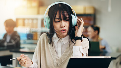 Buy stock photo Headphones, tablet and woman at university with notes for literature assignment in class. Reading, pen and Japanese female student with digital technology studying for college exam, test or project.