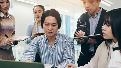 Buy stock photo Japanese people, group and laptop for business meeting, collaboration and writing notes in office. Teamwork, together and technology for brainstorming, discussion and project management as colleagues