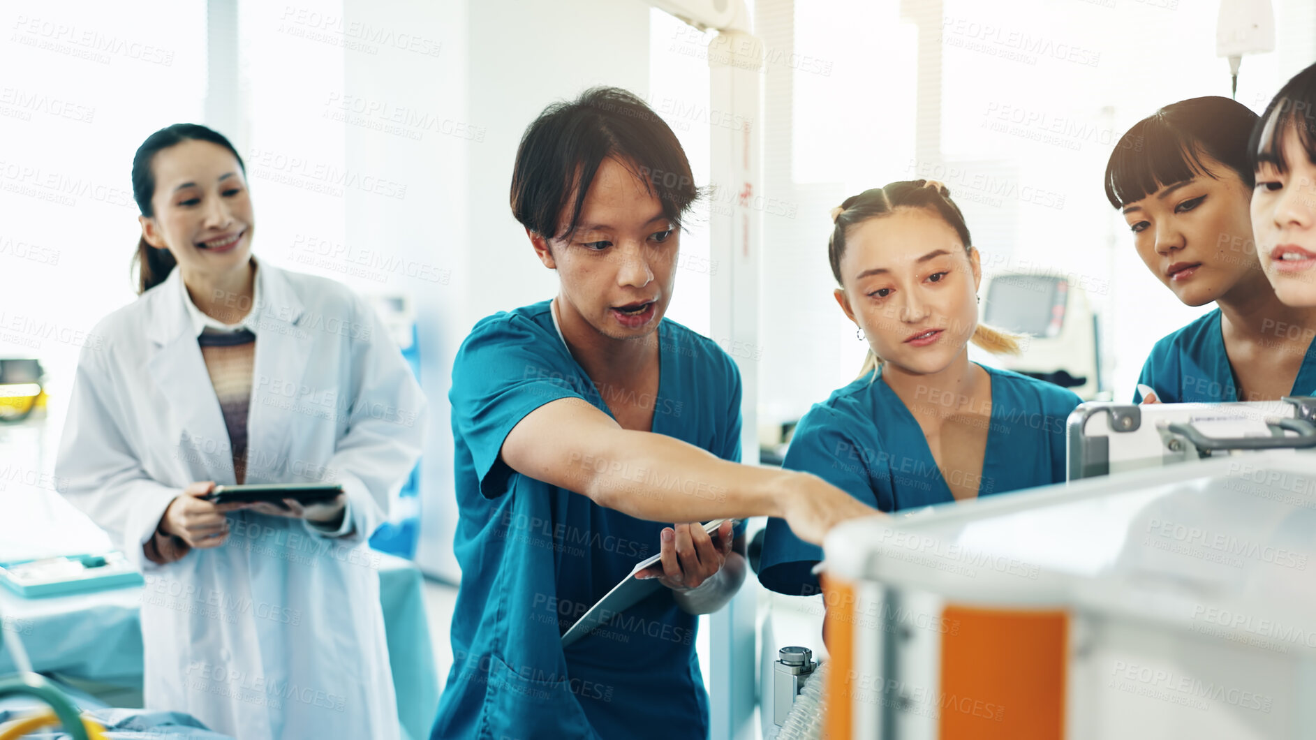 Buy stock photo Doctor, students and machine for medical lecture, education or practical assignment in hospital. Research, learn and group with professor for training on healthcare technology at university in Japan.