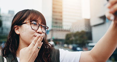 Buy stock photo Japanese woman, selfie and travel in street with kiss, sign and outdoor in summer with post on web. Girl, person and influencer with emoji, symbol and live streaming with social media in urban city