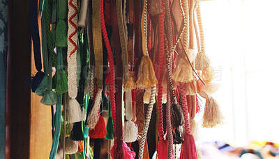 Buy stock photo Shrine, worship and sacred rope for Japanese tradition, history and spiritual practice at holy site, Straw, shinto and outdoor with ritual product or string souvenir with travel, culture and Japan