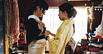 Asian woman, dress and fashion designer with garment for kimono, culture or tradition style at boutique. Japan, female people or tailor with customer, waist belt or clothing design for outfit at shop