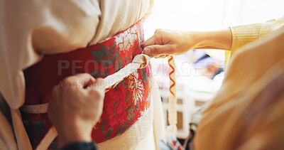 Buy stock photo Hands, woman and fitting kimono at tailor, dress maker and fashion in boutique. People, designer and style clothing for culture tradition in Japan, fabric check and closeup of tying belt at shop