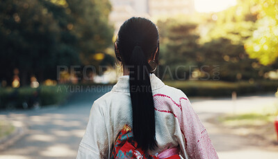 Buy stock photo Outdoor, park and Japanese woman with walk, fashion and travel with trip and holiday in Tokyo. City, kimono and back with journey, vacation and traditional clothes with pavement, path and style