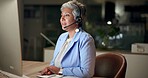 Call center, computer and mature woman telemarketing, consulting or help desk at night in office. Headset, insurance agent and customer service for support, business advice and contact us on deadline