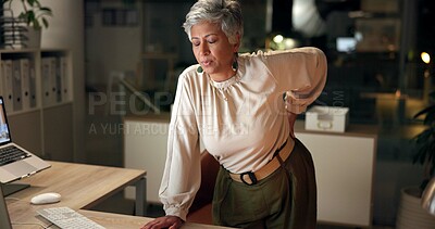 Buy stock photo Business, woman and back pain in office at night with overtime burnout, osteoporosis and deadline stress. Mature accountant, joint ache and medical emergency of injury, muscle tension and tendinitis 