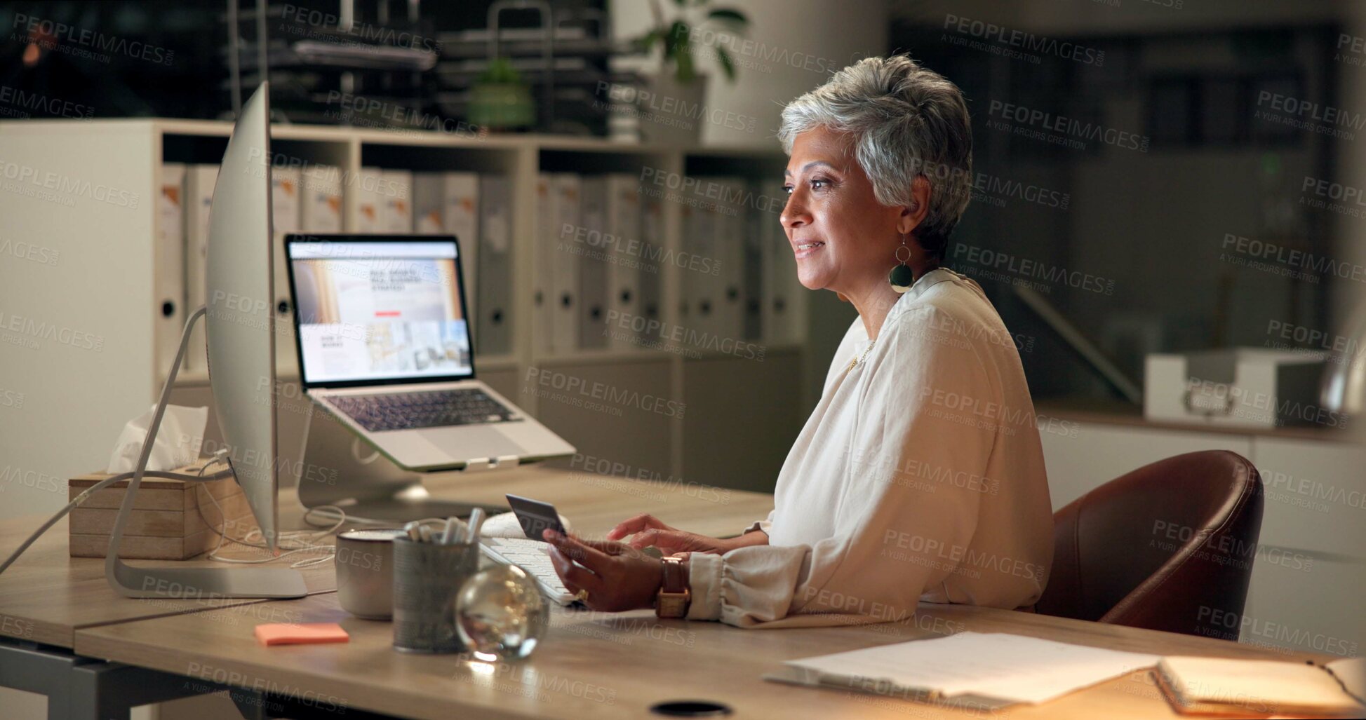 Buy stock photo Credit card, computer and mature businesswoman in office purchasing supplies for company at night. Technology, bank account and female financial executive with online investment in workplace.